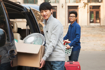 Students moving into dormitory on college campus